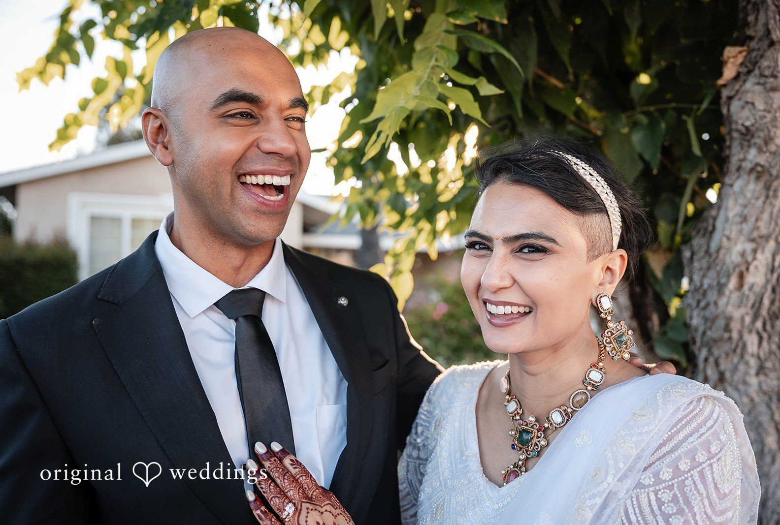 Bride and groom laughing together, captured by San Francisco wedding photographers from Original Weddings at a California backyard wedding