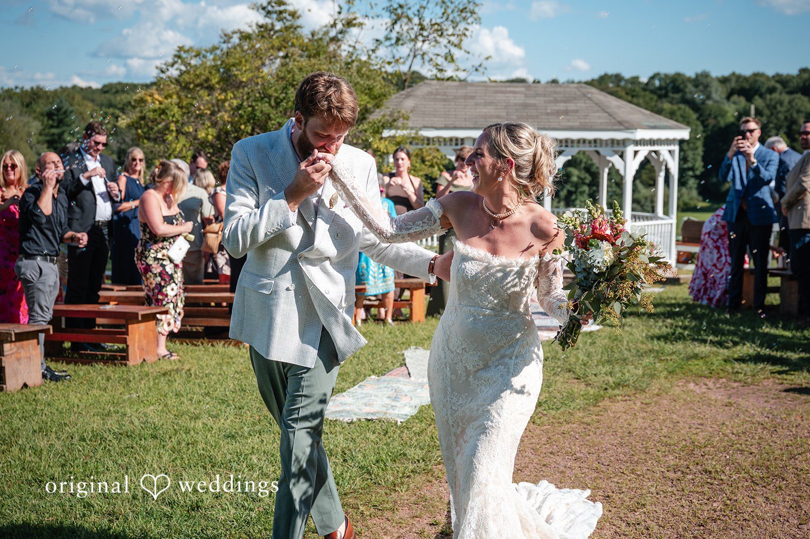 Couple walking back up the aisle at Camp Kweebec