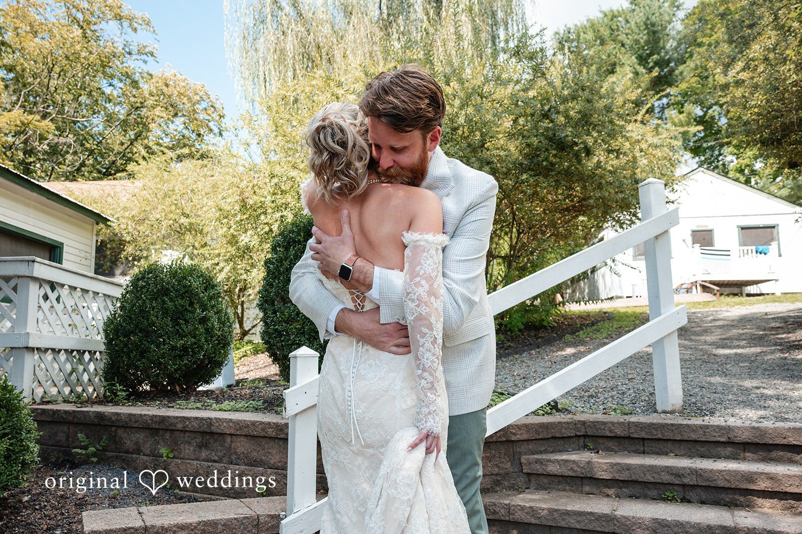 Couple hugging by the stairs