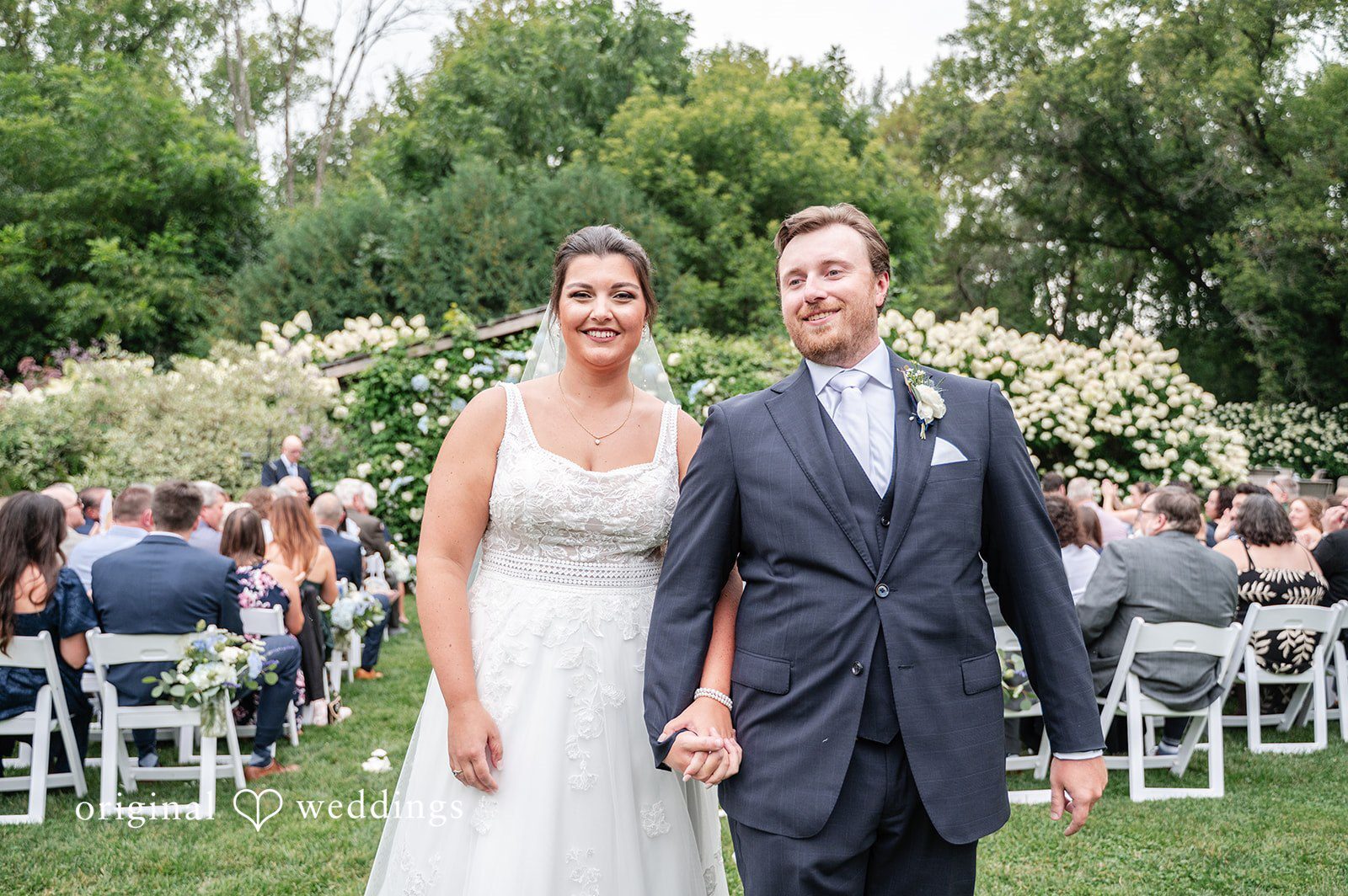 Our Minneapolis wedding photographers at Original Weddings captured the couple making a beautiful exit after their wedding ceremony at Camrose Hill
