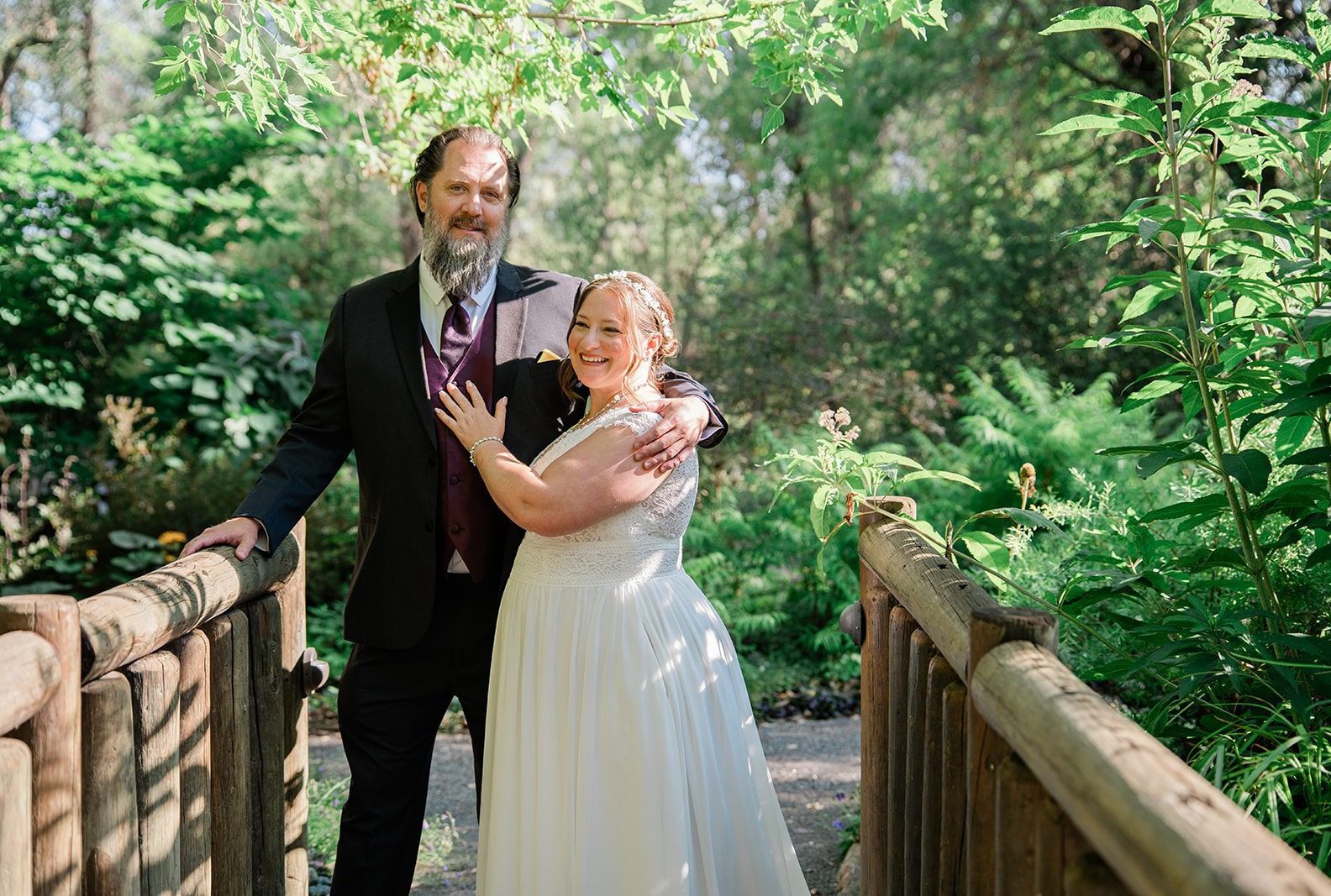 Bride and groom on the wooden bridge, captured by Denver wedding photographers from Original Weddings at Chatfield Farms
