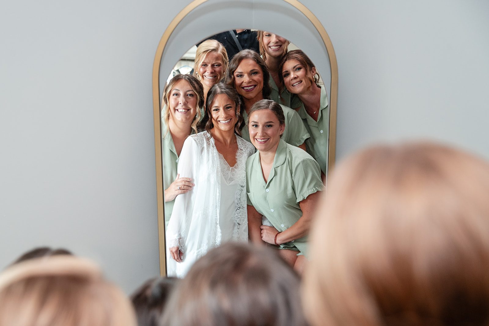 chesapeake-bay-beach-club-timeless-baltimore-kelsey-tom-009-25 Bride getting ready with her bridesmaids at the mirror