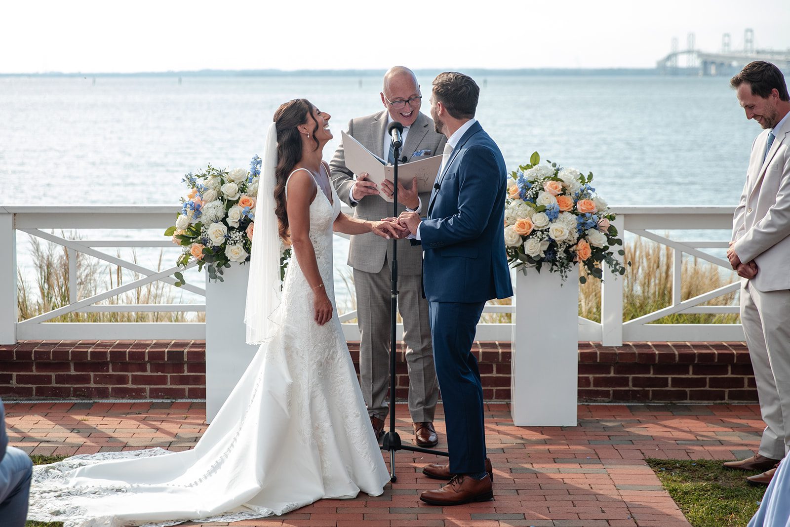 chesapeake-bay-beach-club-timeless-baltimore-kelsey-tom-020-43 Bride and groom exchanging vows by the bay