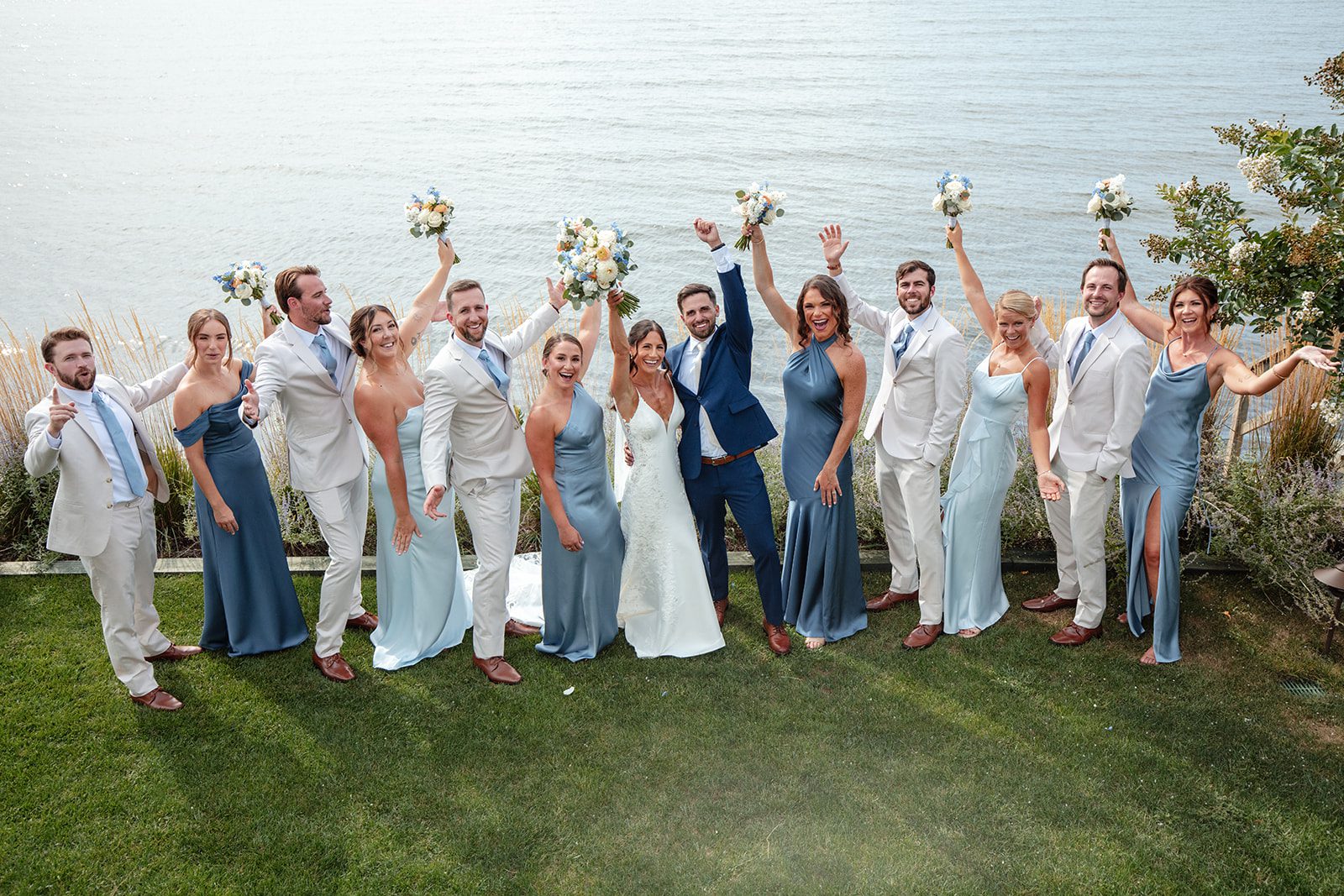 chesapeake-bay-beach-club-timeless-baltimore-kelsey-tom-041-10 Wedding party cheering with the couple