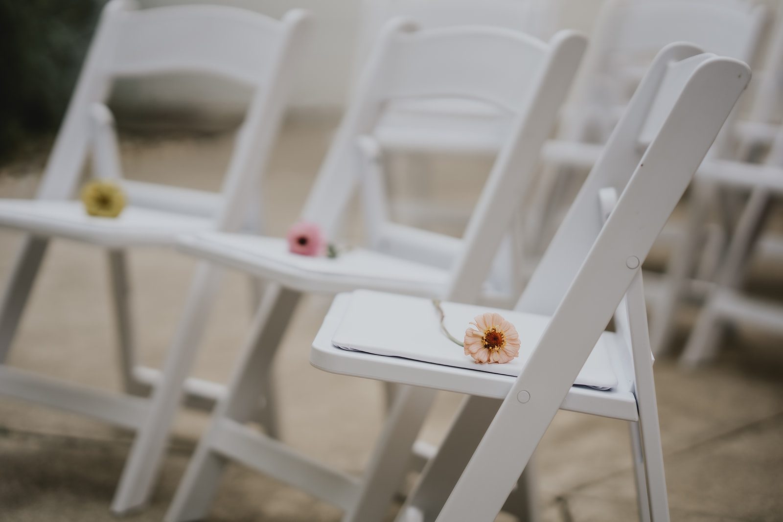 White ceremony chairs with flower details
