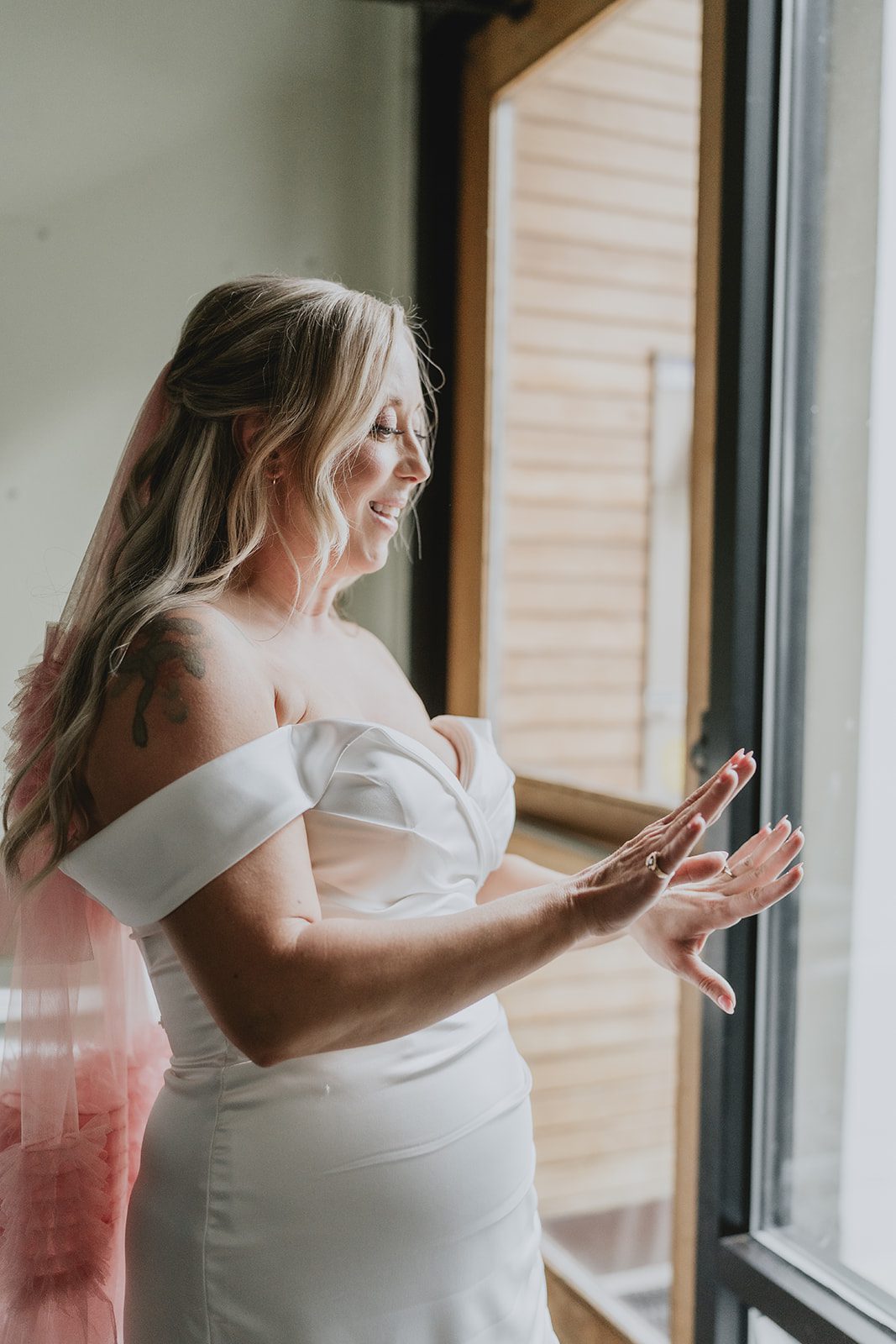 Bride getting ready by the window