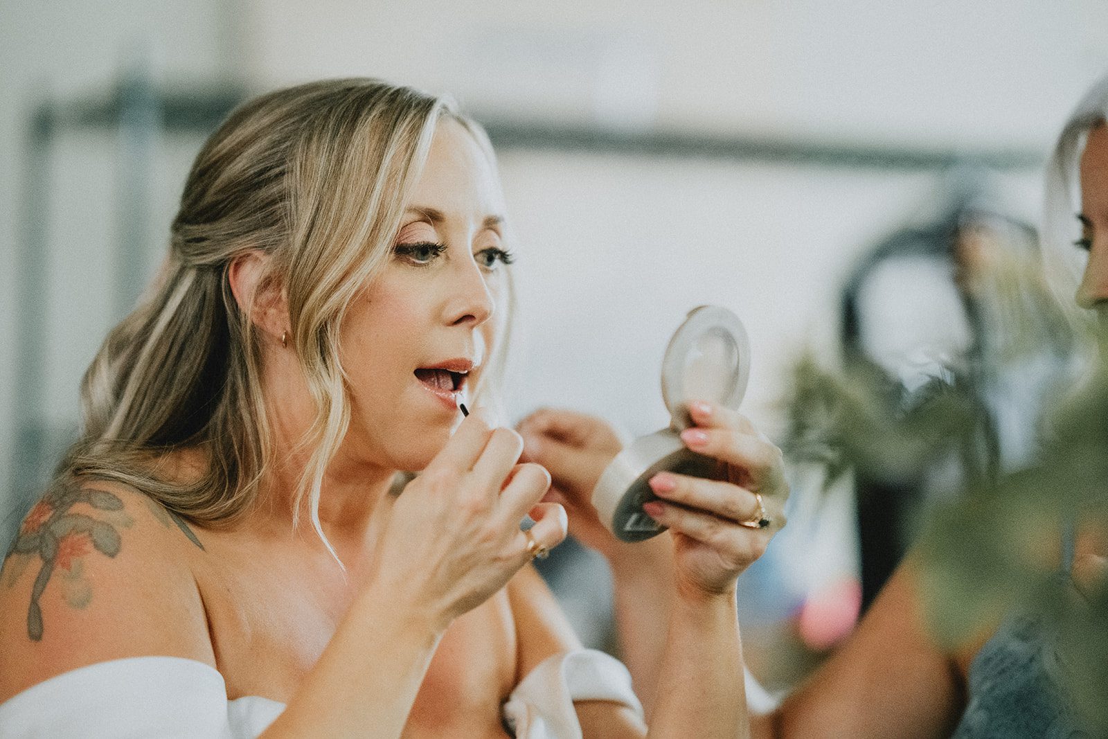 Bride touching up her makeup