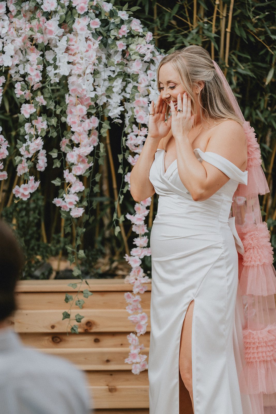 Bride in front of the floral wisteria wall