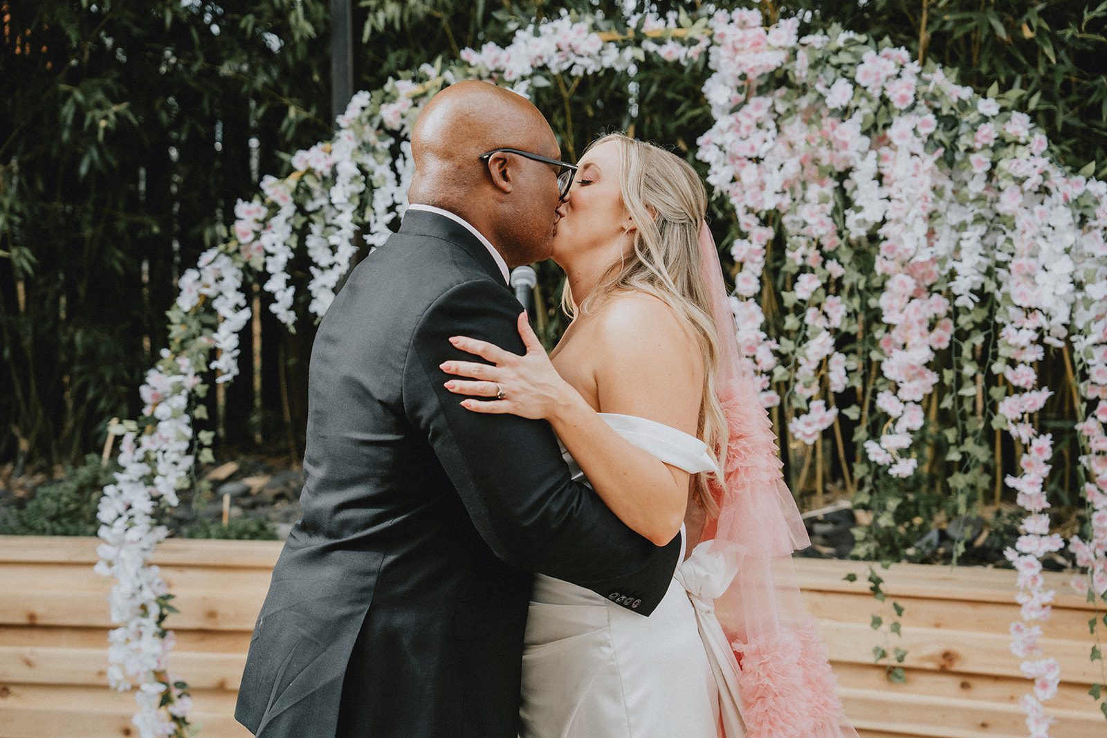 First kiss under the floral arch at Chill Chill Chill