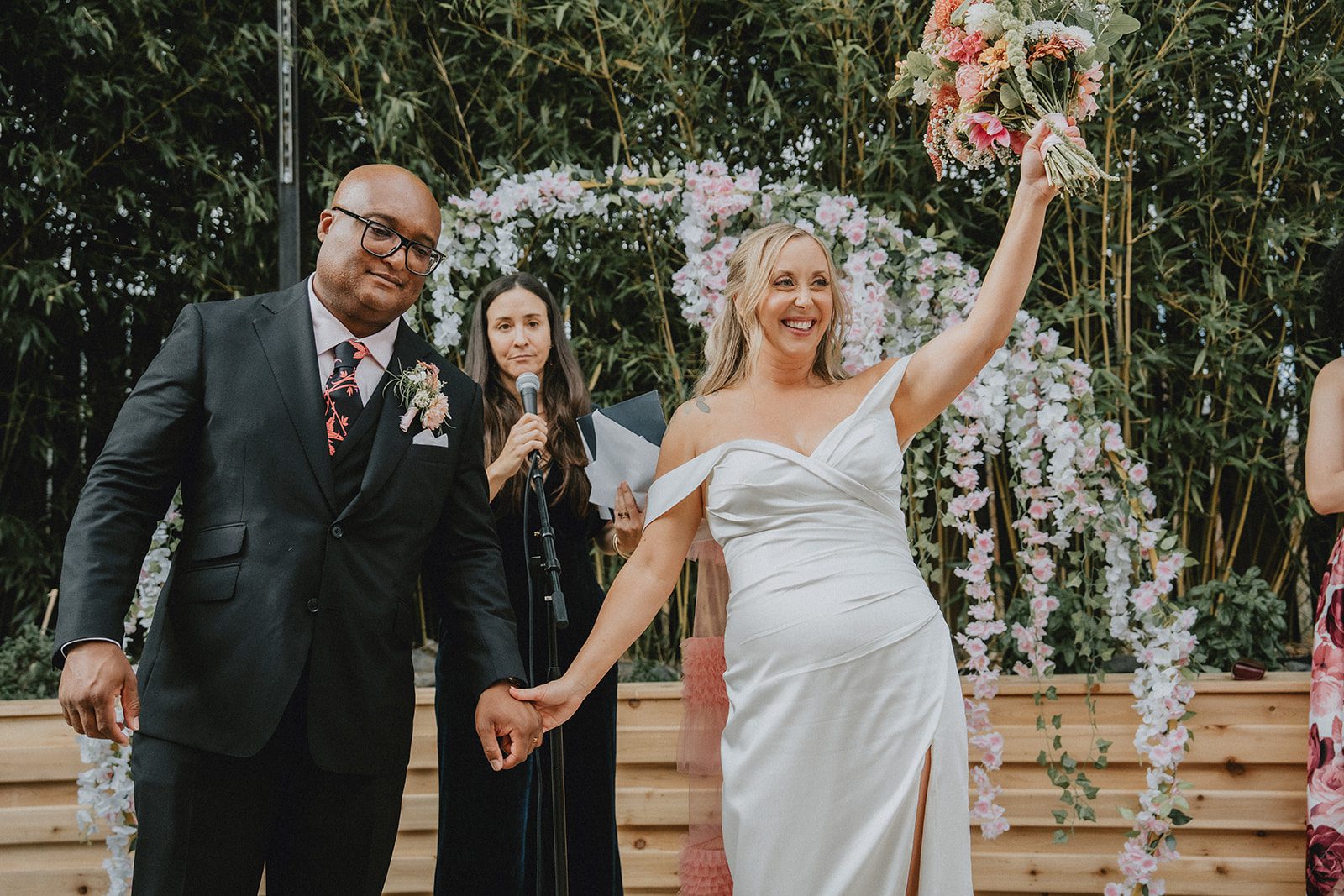Newlyweds celebrating with arms raised