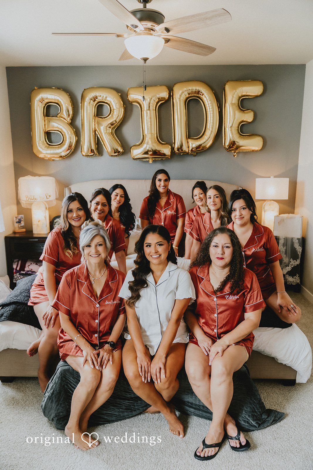 Sonia + Michael Bride and bridesmaids celebrating with a bride sign while getting ready