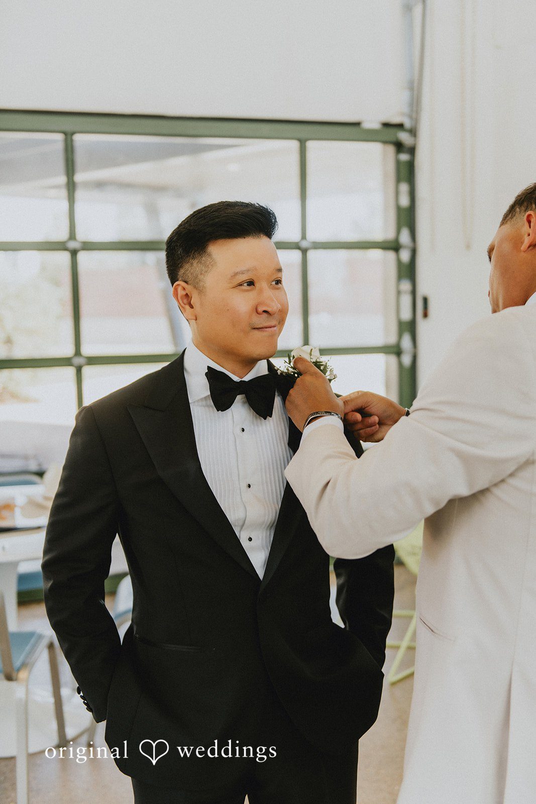 Sonia + Michael Groom getting ready as his boutonniere is pinned on
