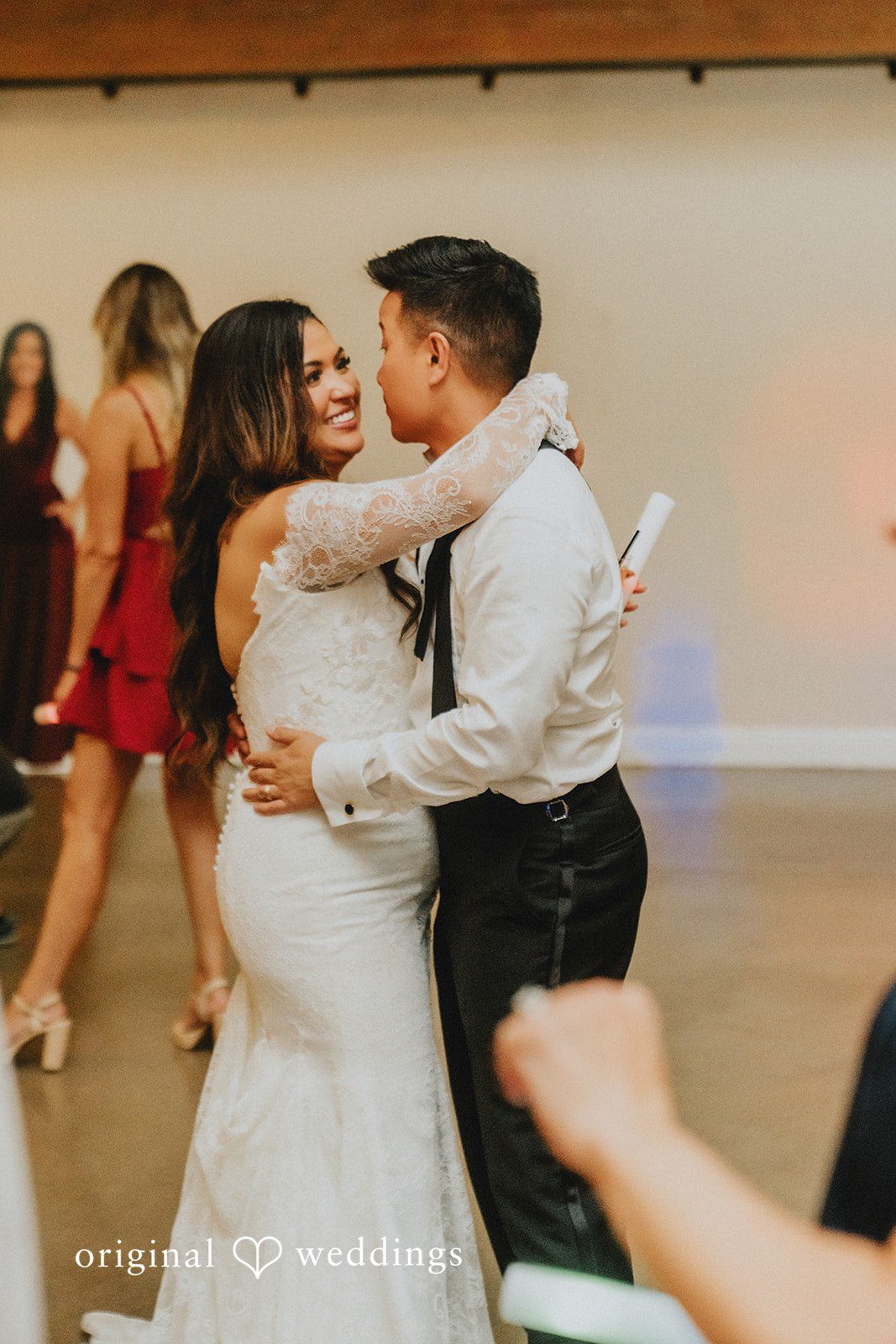 Sonia + Michael Couple dancing together surrounded by guests