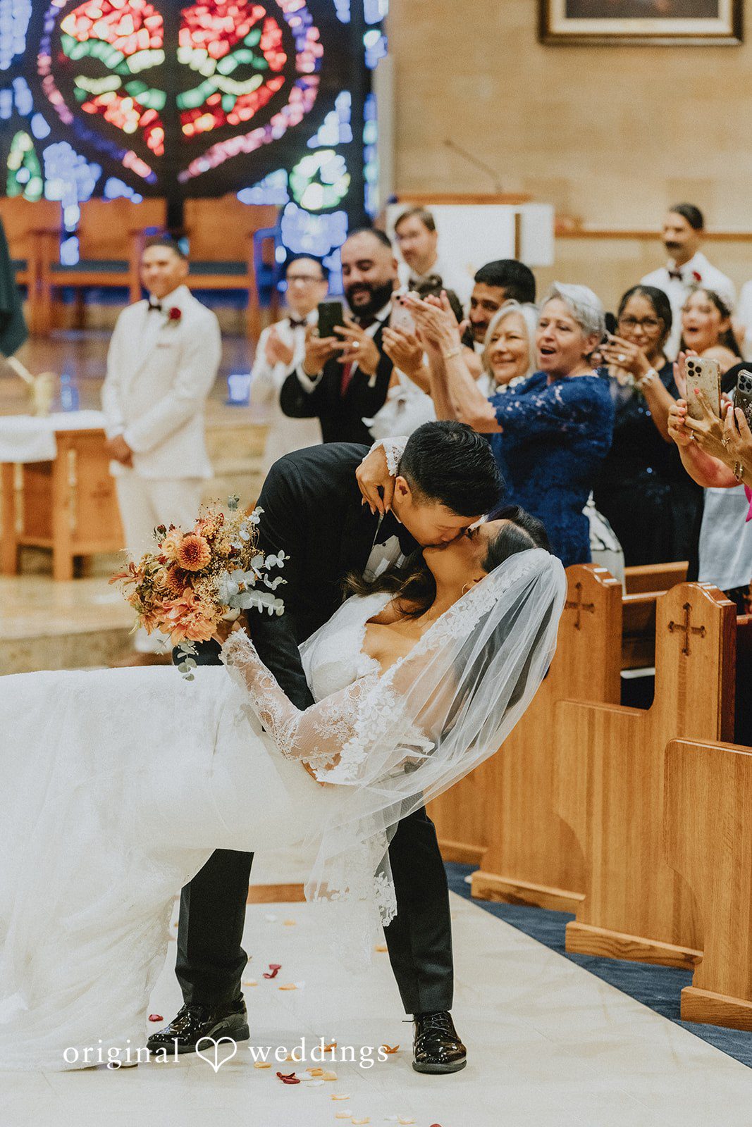 Sonia + Michael Newlyweds celebrating with guests in the church aisle