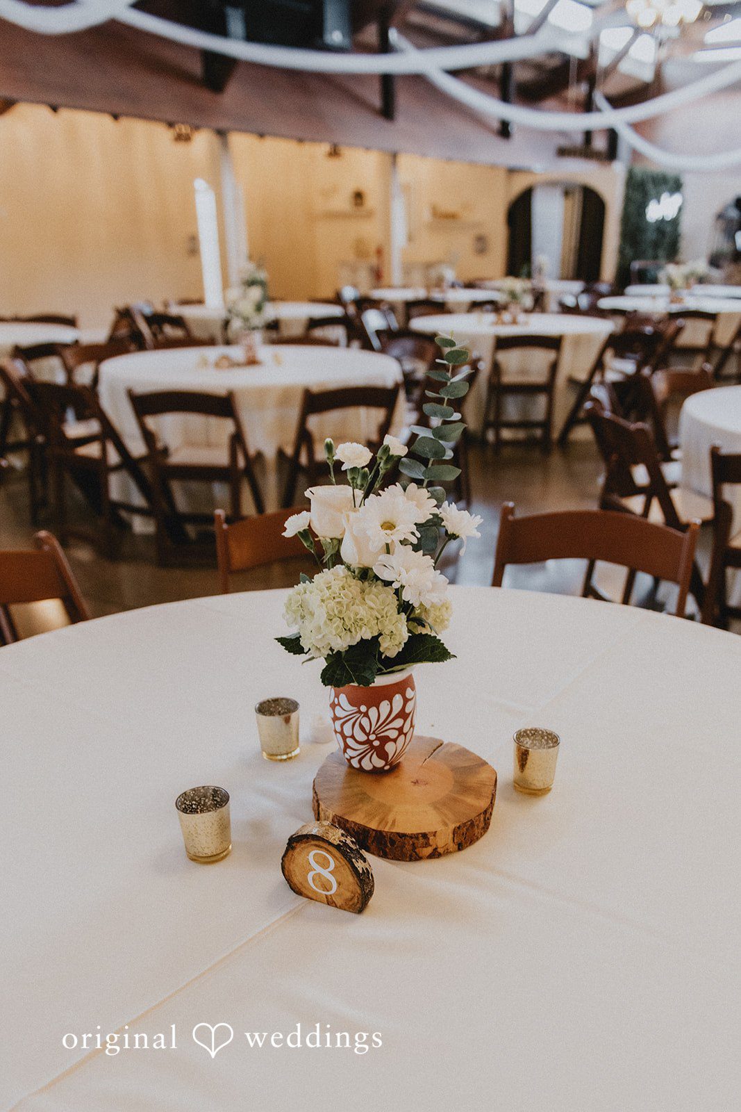 Sonia + Michael Reception table centerpiece with candles and flowers at Church Ranch Event Center