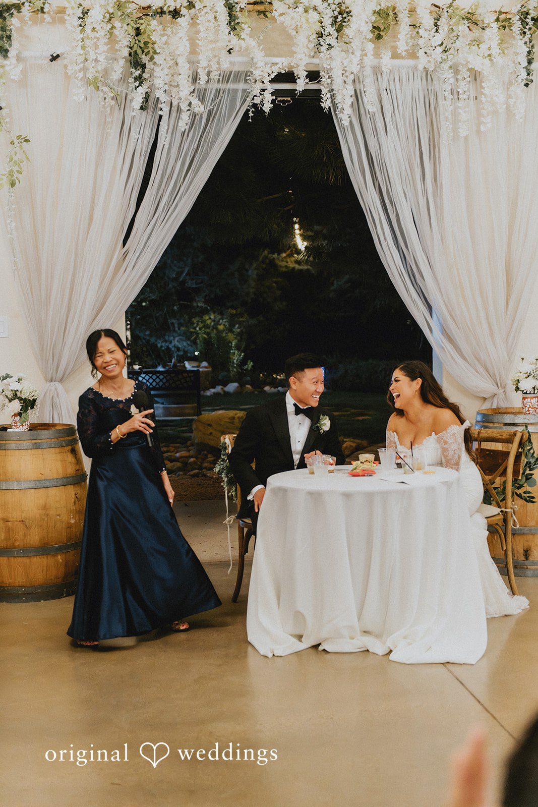 Sonia + Michael Sweetheart table with draped curtains at Church Ranch Event Center