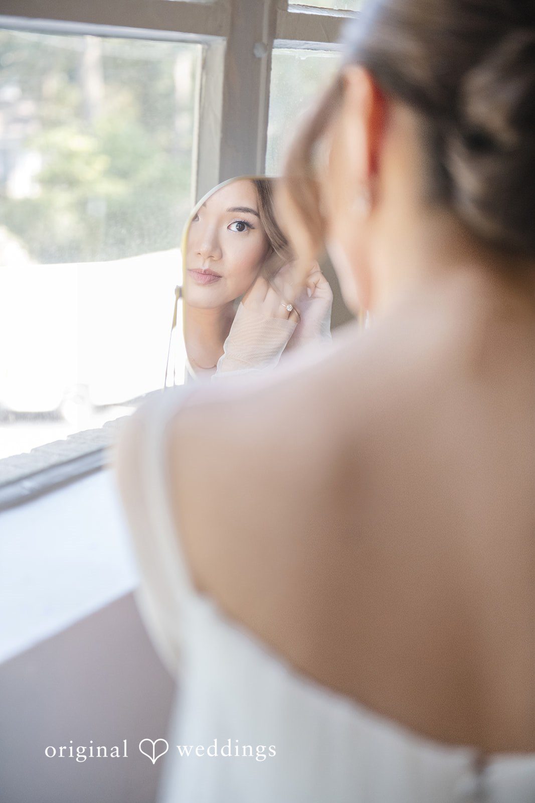 Yuri + Zachary Bride getting ready by the window at Collier Hall