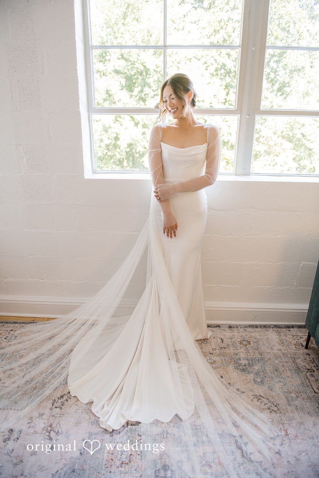 Yuri + Zachary Bride in her gown in the bright bridal suite at Collier Hall