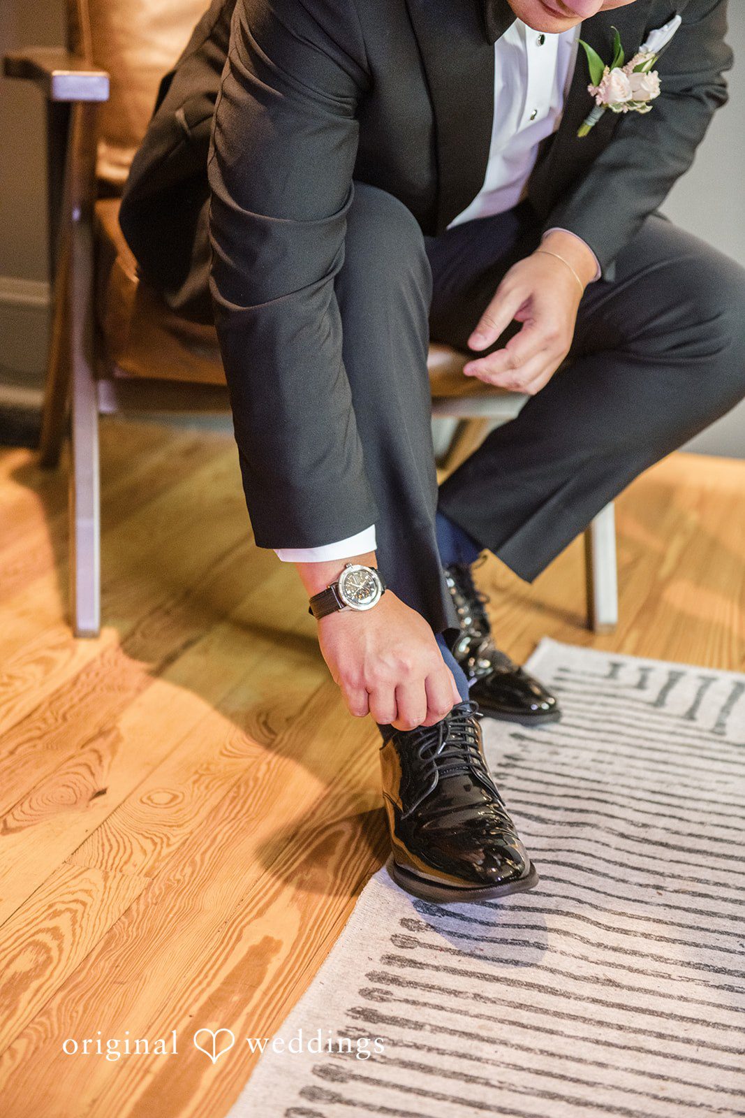 Yuri + Zachary Groom tying his shoes before the ceremony
