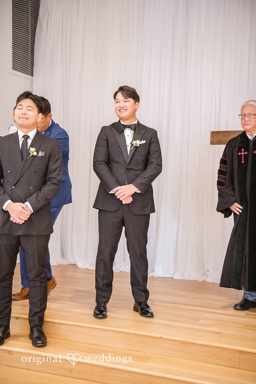 Yuri + Zachary Groom standing with a groomsman
