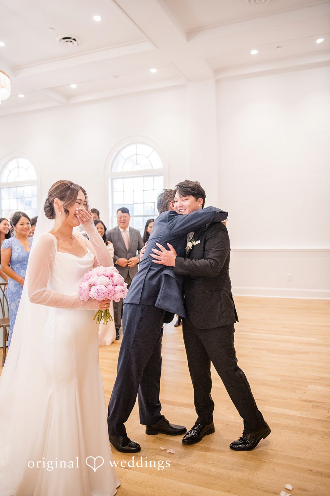 Yuri + Zachary Couple hugging family after the ceremony