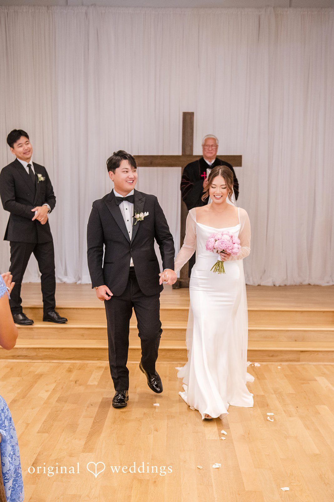 Yuri + Zachary Couple with their officiant by the cross