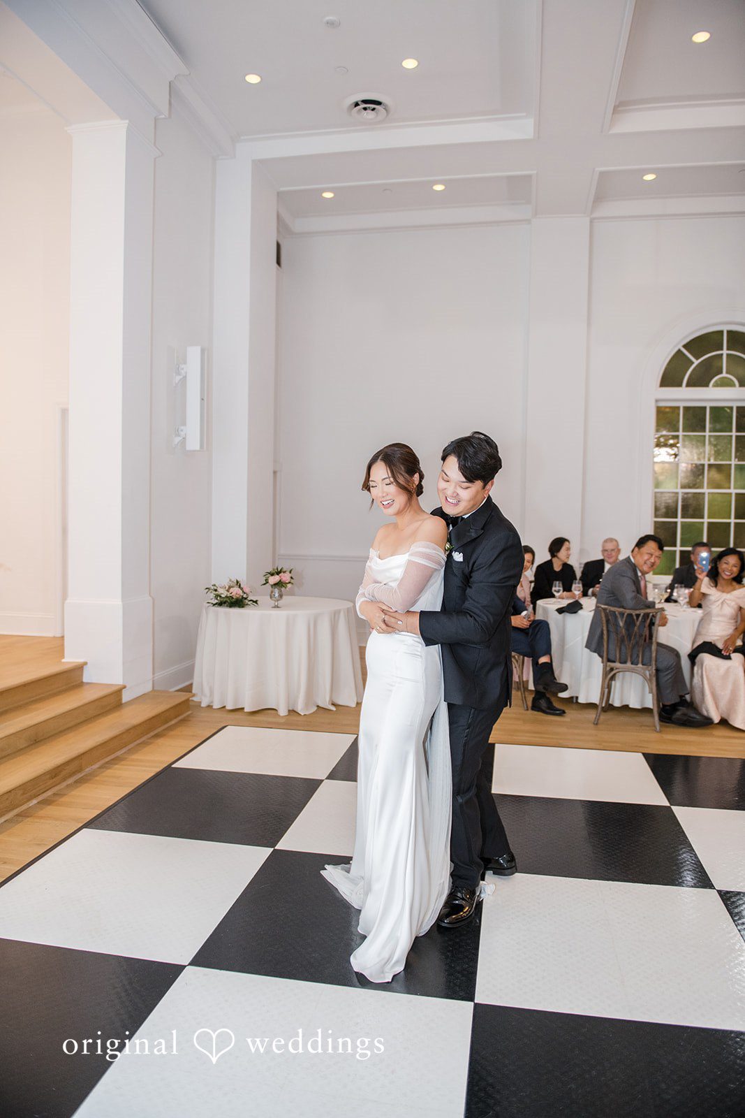 Yuri + Zachary Couple standing at the front of the hall at Collier Hall