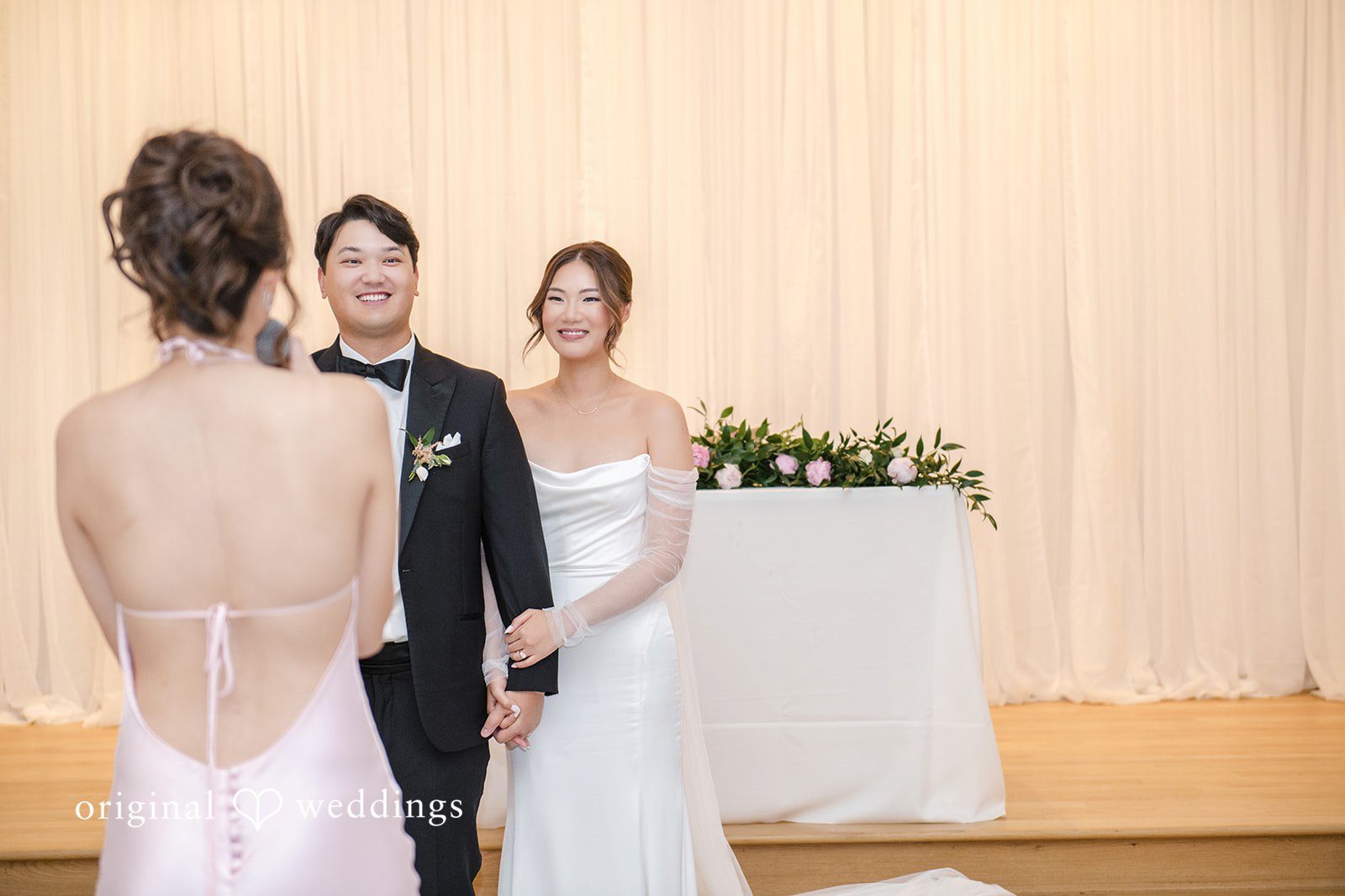 Yuri + Zachary Bride and groom sharing a moment with a guest