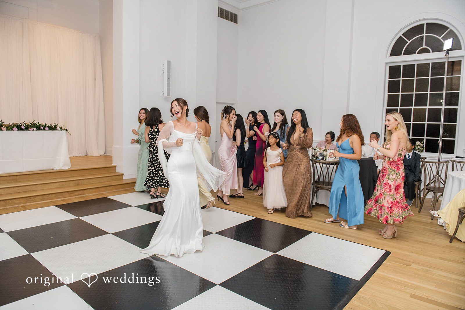 Yuri + Zachary Bride walking down the aisle past guests at Collier Hall
