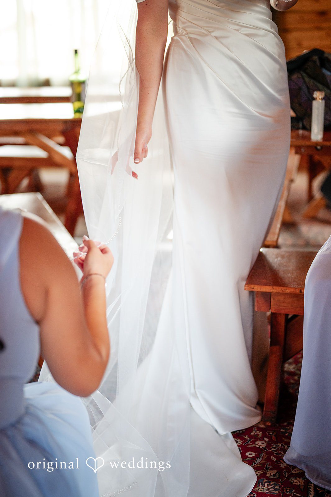 Erin + John Bride being buttoned into her gown