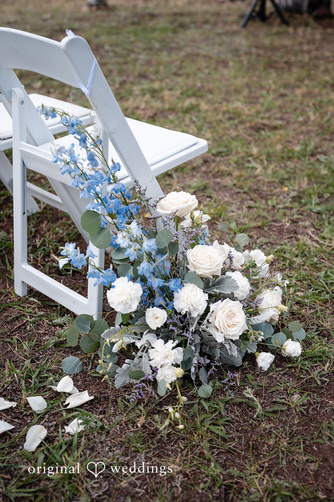 Erin + John White and blue florals on the aisle chairs at the Colorado backyard wedding