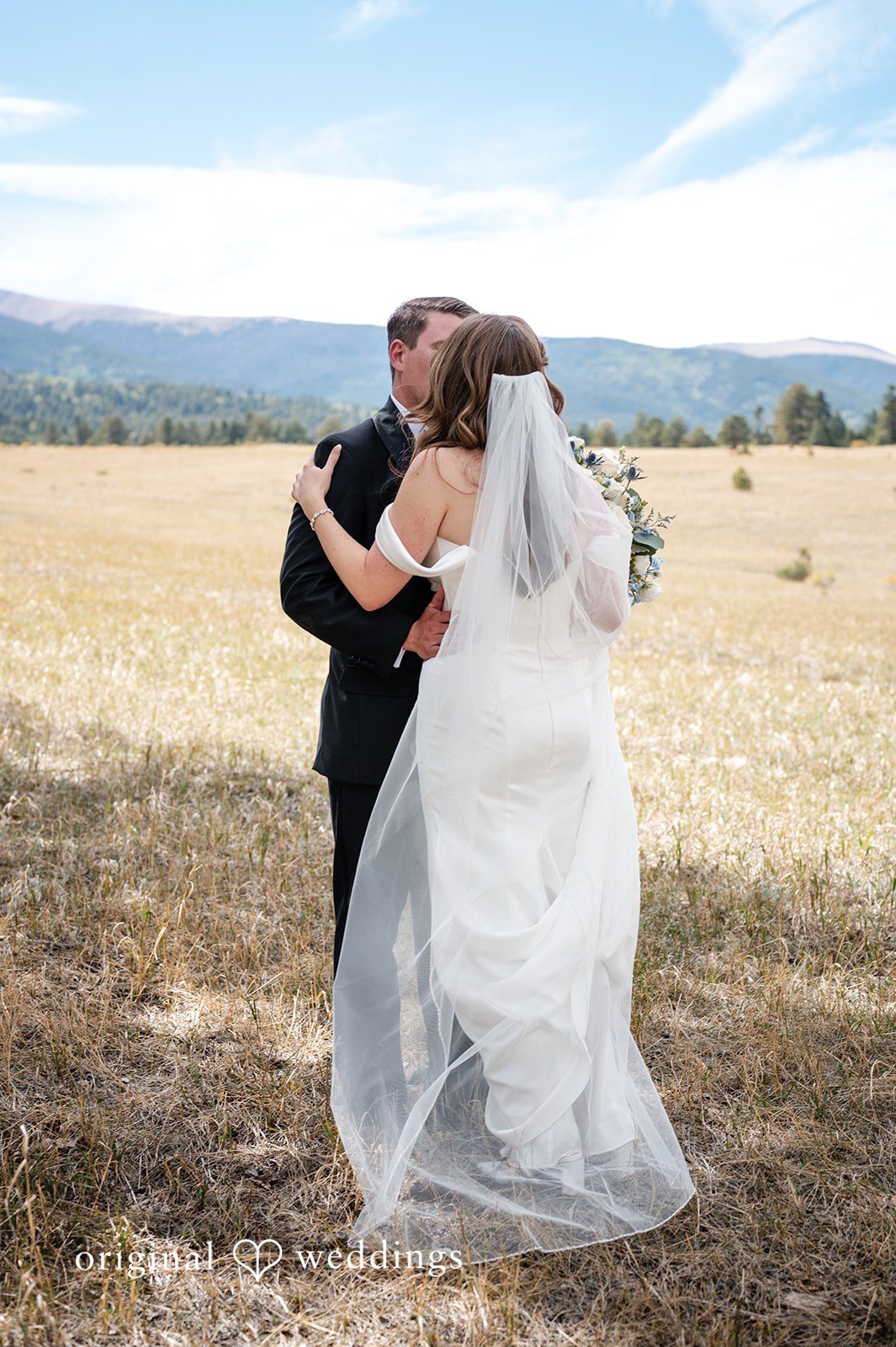 Erin + John Bride and groom kissing in the meadow