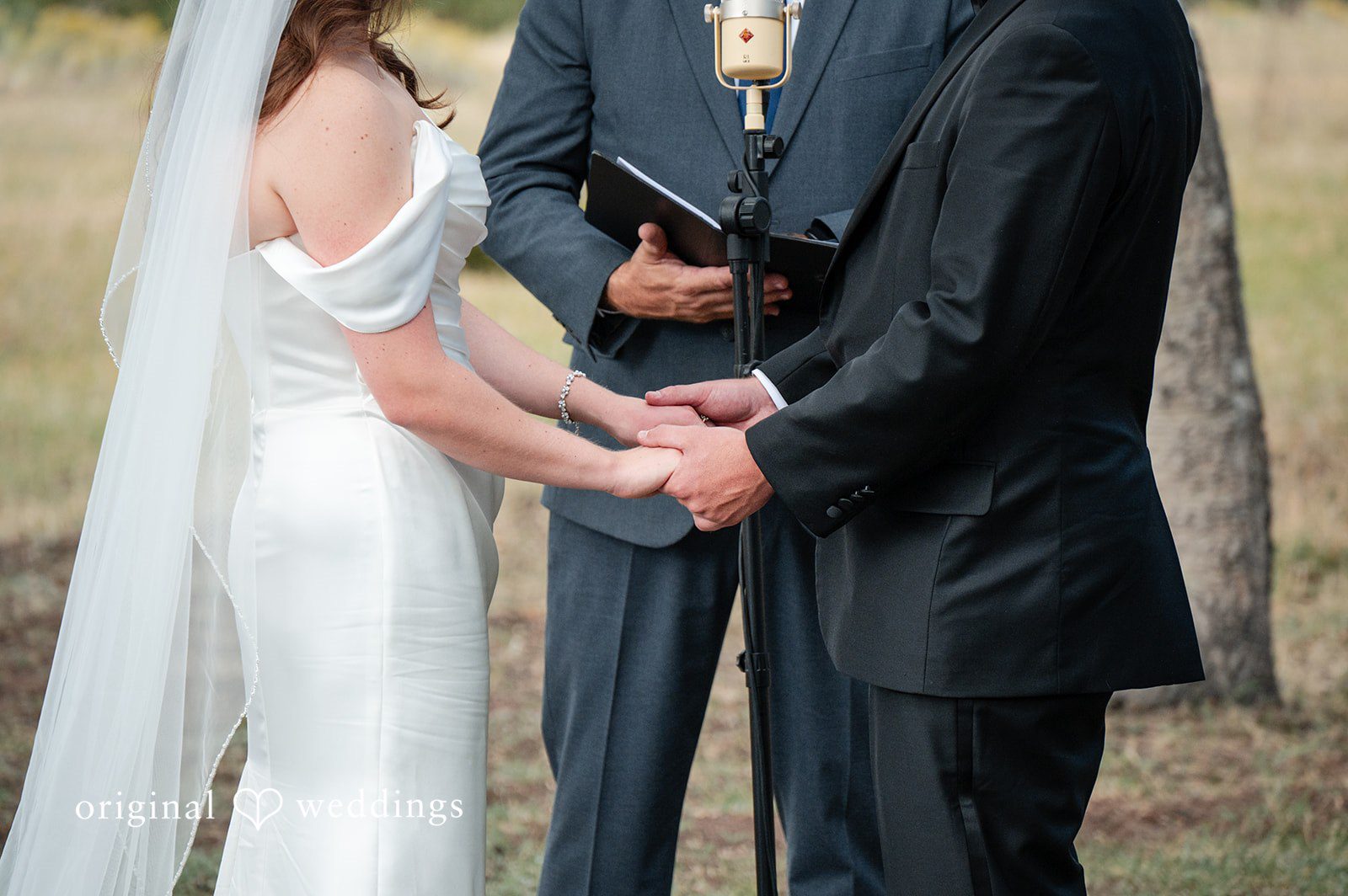 Erin + John Couple holding hands during their vows