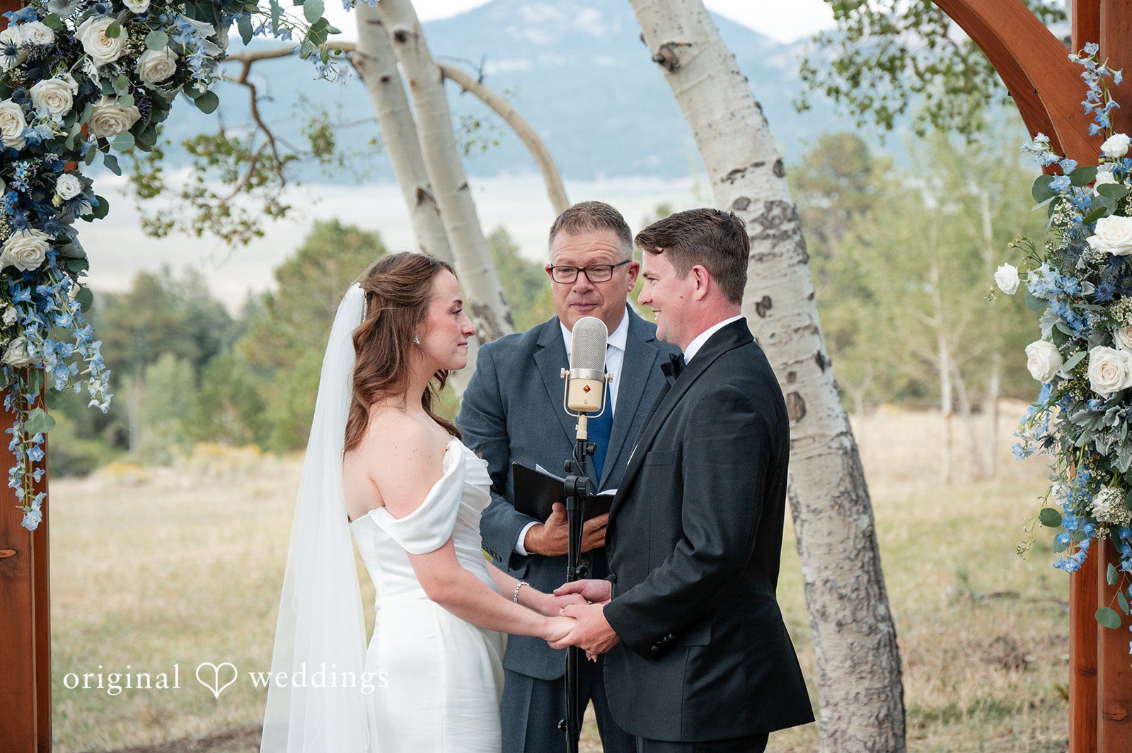 Erin + John Erin and John with the officiant at the arch