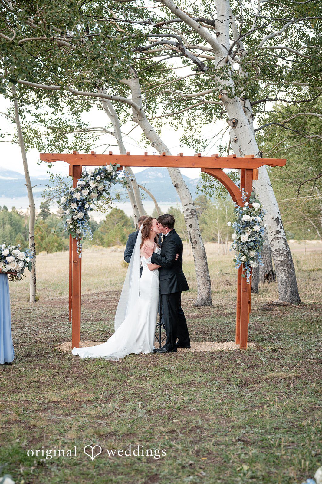 Erin + John Ceremony under the wooden arch among the aspens