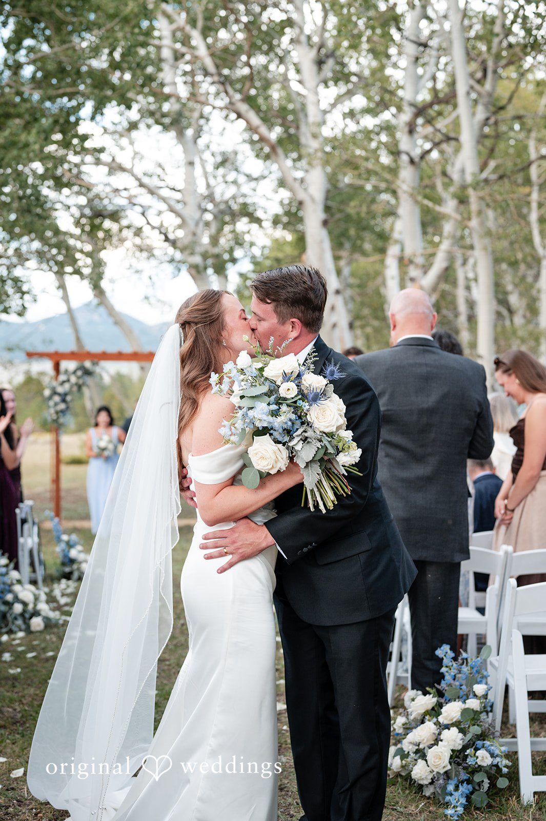 Erin + John First kiss at the Colorado backyard wedding