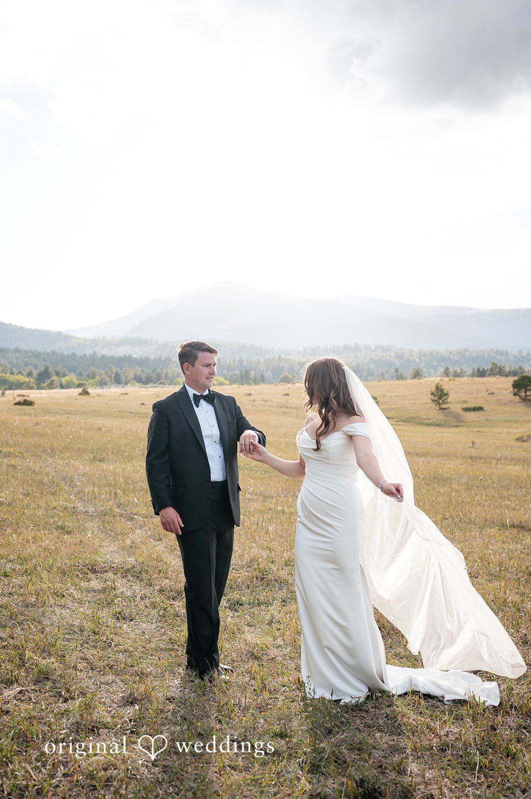 Erin + John Couple in the open field at the Colorado backyard wedding