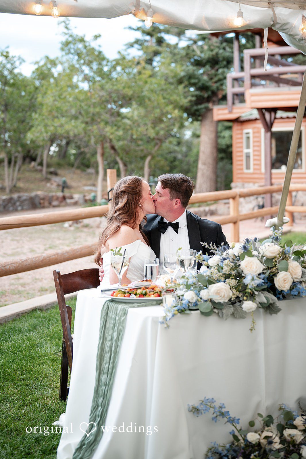 Erin + John Sweetheart table with white florals outdoors