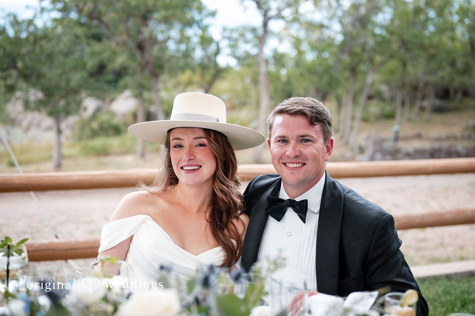 Erin + John Erin and John laughing together outdoors, captured by Denver wedding photographers from Original Weddings at their Colorado backyard wedding
