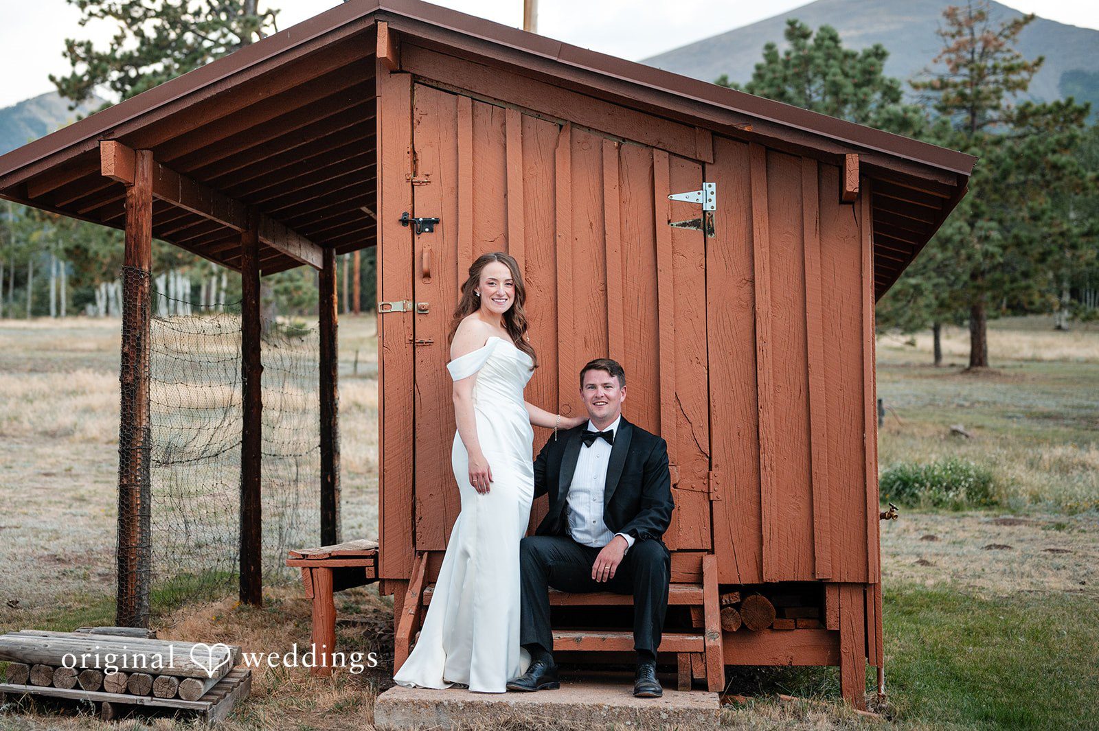 Erin + John Couple sitting by the rustic shed