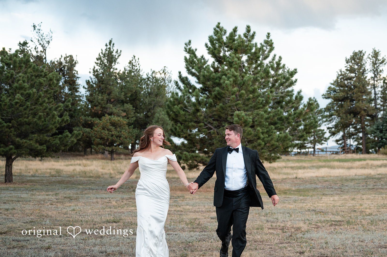 Erin + John Bride and groom strolling through the meadow