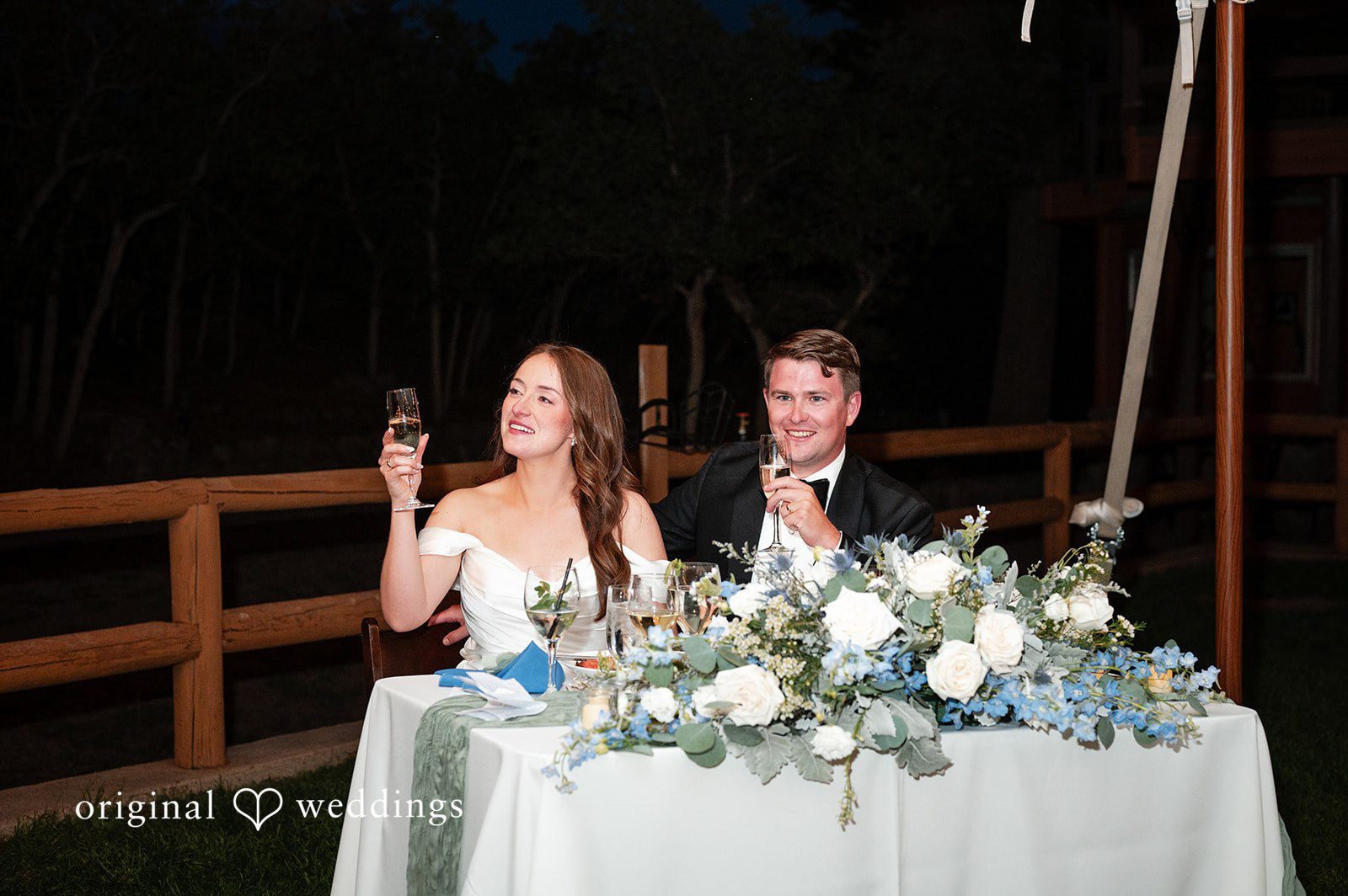 Erin + John Couple at the sweetheart table at night
