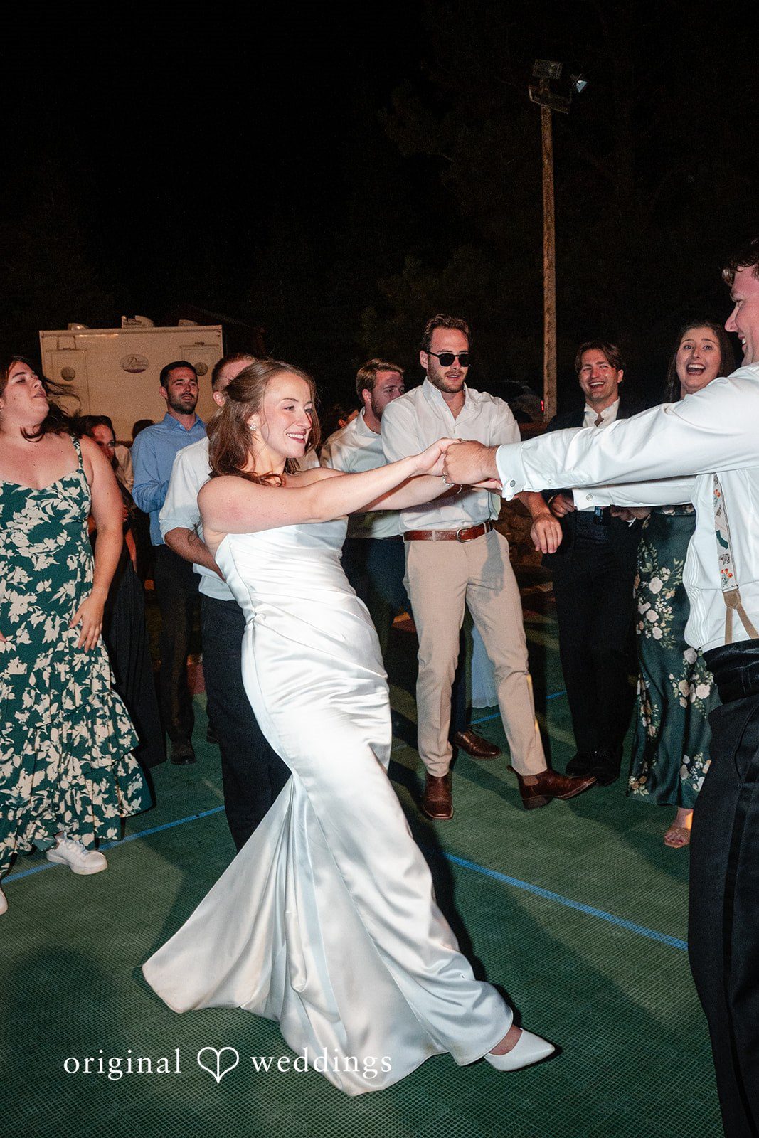 Erin + John Bride dancing with guests at night