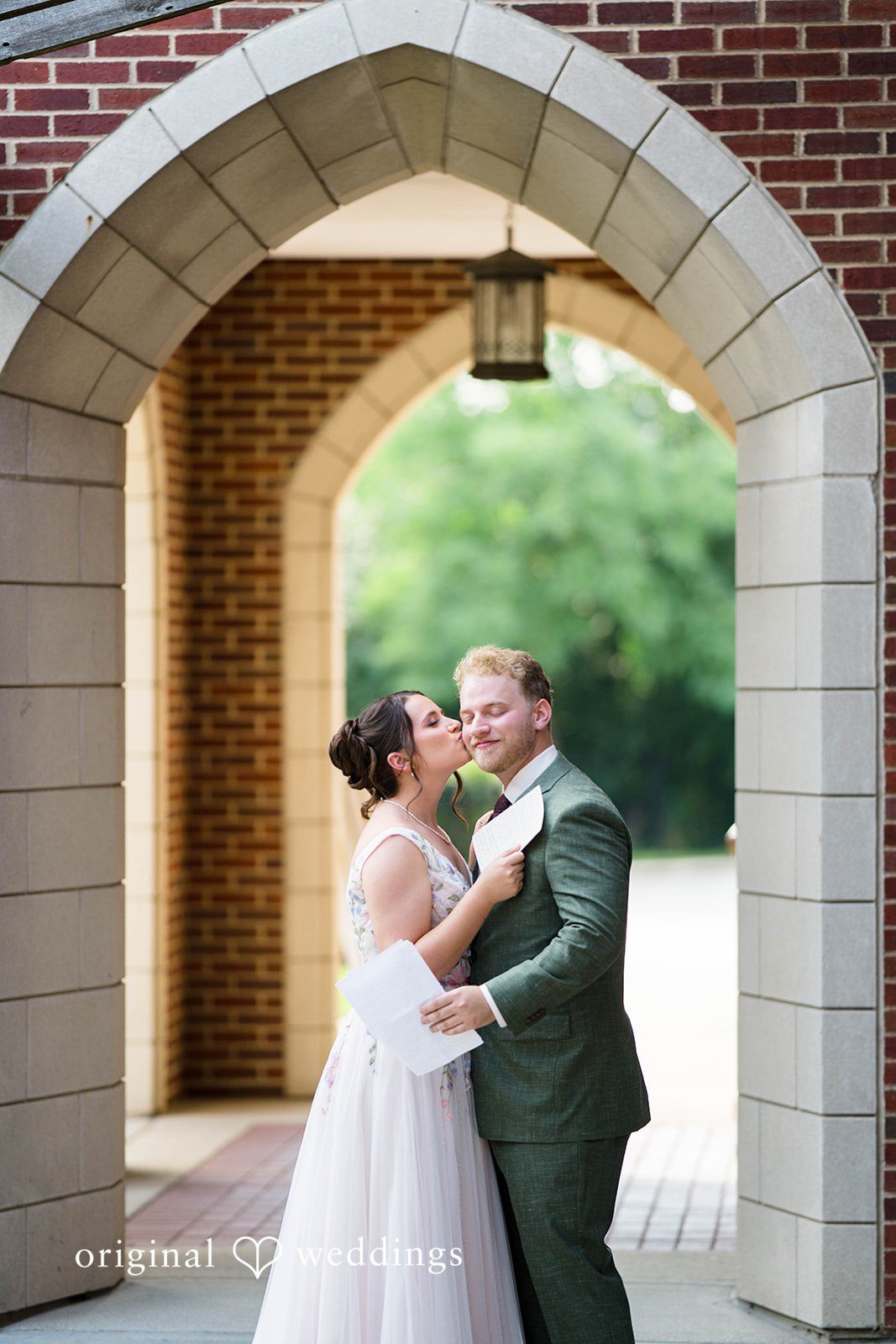 Griffin + Lauren Couple kissing under a brick archway