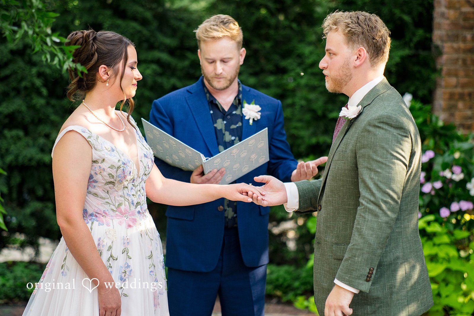 Griffin + Lauren Couple exchanging rings with the officiant