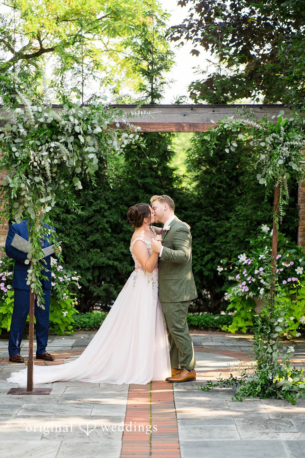 Griffin + Lauren Couple in the garden near the pergola