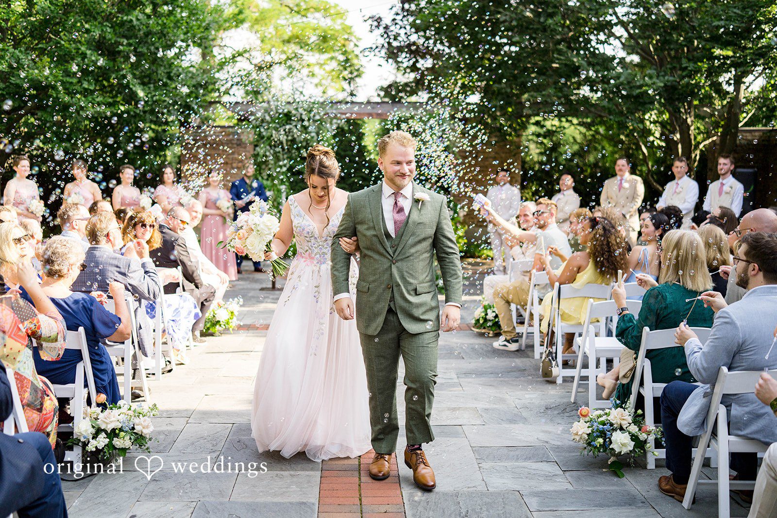 Griffin + Lauren Guests cheering as the couple walks back up the aisle at Community House Winnetka