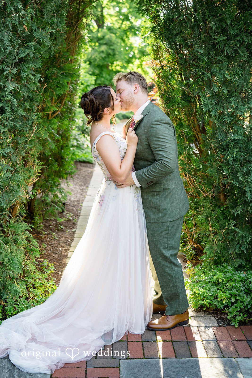 Griffin + Lauren Couple kissing among the greenery
