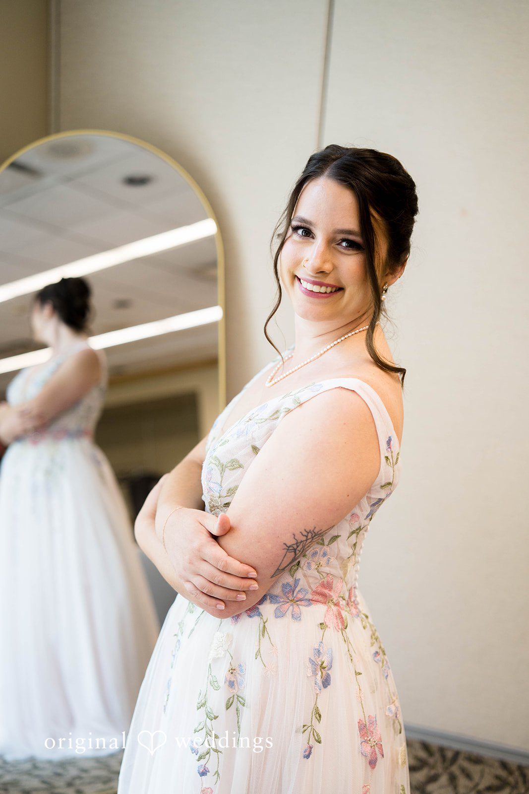 Griffin + Lauren Bride getting ready in front of a mirror