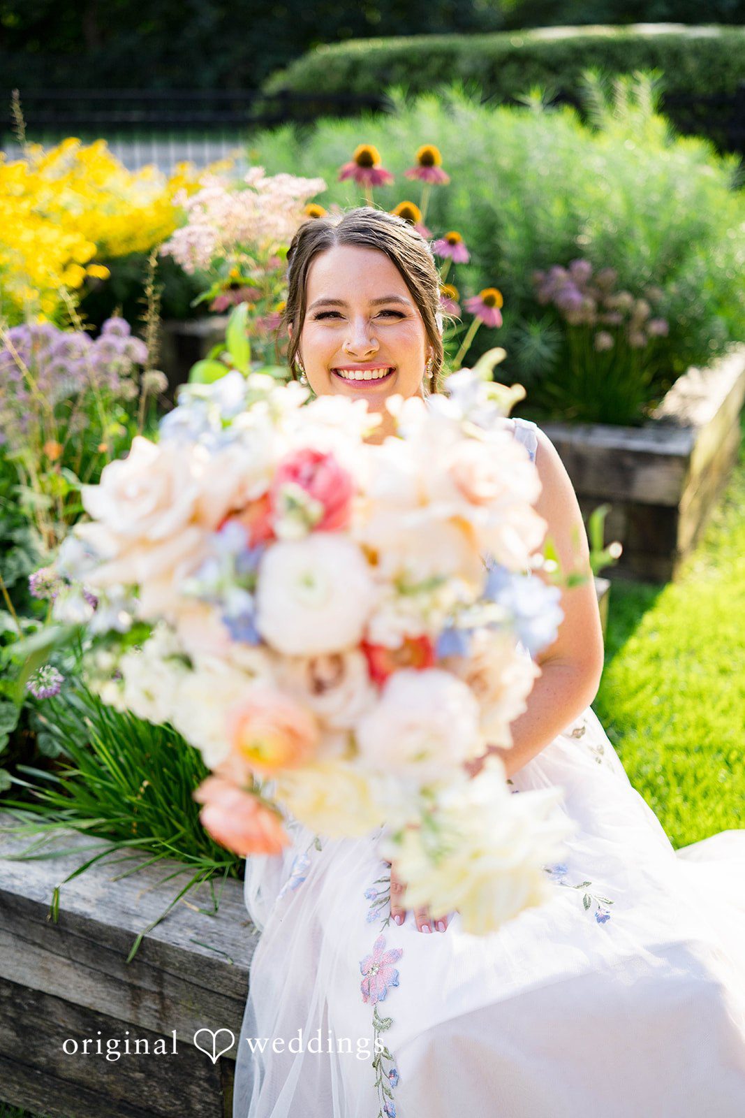 Griffin + Lauren Bride holding her colorful bouquet